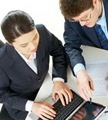 Young man and woman using a laptop to medical train